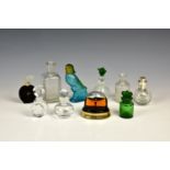 A collection of glass scent bottles, including an Avon parrot form bottle; a Whitefriars style