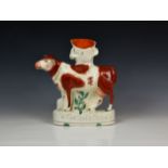 A 19th century Staffordshire Pottery advertising shop window spill vase cow, fashioned chained to