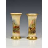 A closely matched pair of Royal Worcester porcelain trumpet vases, shaped no. G923, painted with