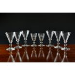 A set of six late-Georgian wine glasses, the panel cut trumpet bowls on a bladed collar and bladed