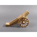 An unusual carved ivory model cannon, probably French, 18th century, with overall bas relief