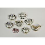 A small collection of eight bone china and enamel decanter labels, comprising 'BRANDY' and '