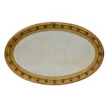 A Victorian oval giltwood mirror, the bevelled plate within a reeded and crossed ribbon frame with