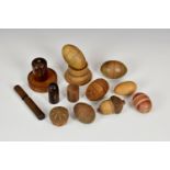 A group of various treen containers, comprising two carved coquilla nut egg form containers,