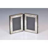 A double hinged silver photo frame, PJP, Birmingham 1984, of rectangular book form, with embossed