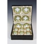 A cased set of six Continental porcelain demitasse cups and saucers, with ornate applied gilt