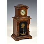 A walnut cased fountain clock by the Hamburg American Clock Company, with crossed arrows mark to the