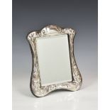 An Art Nouveau style silver easel back dressing table mirror, John Bull Ltd., London 1987, shaped