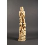 A Japanese carved ivory figure of a woodsman and his wife, Meiji period (1868-1912), he holding an