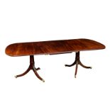 A Regency style mahogany twin pedestal dining table, late 19th century, the top with single