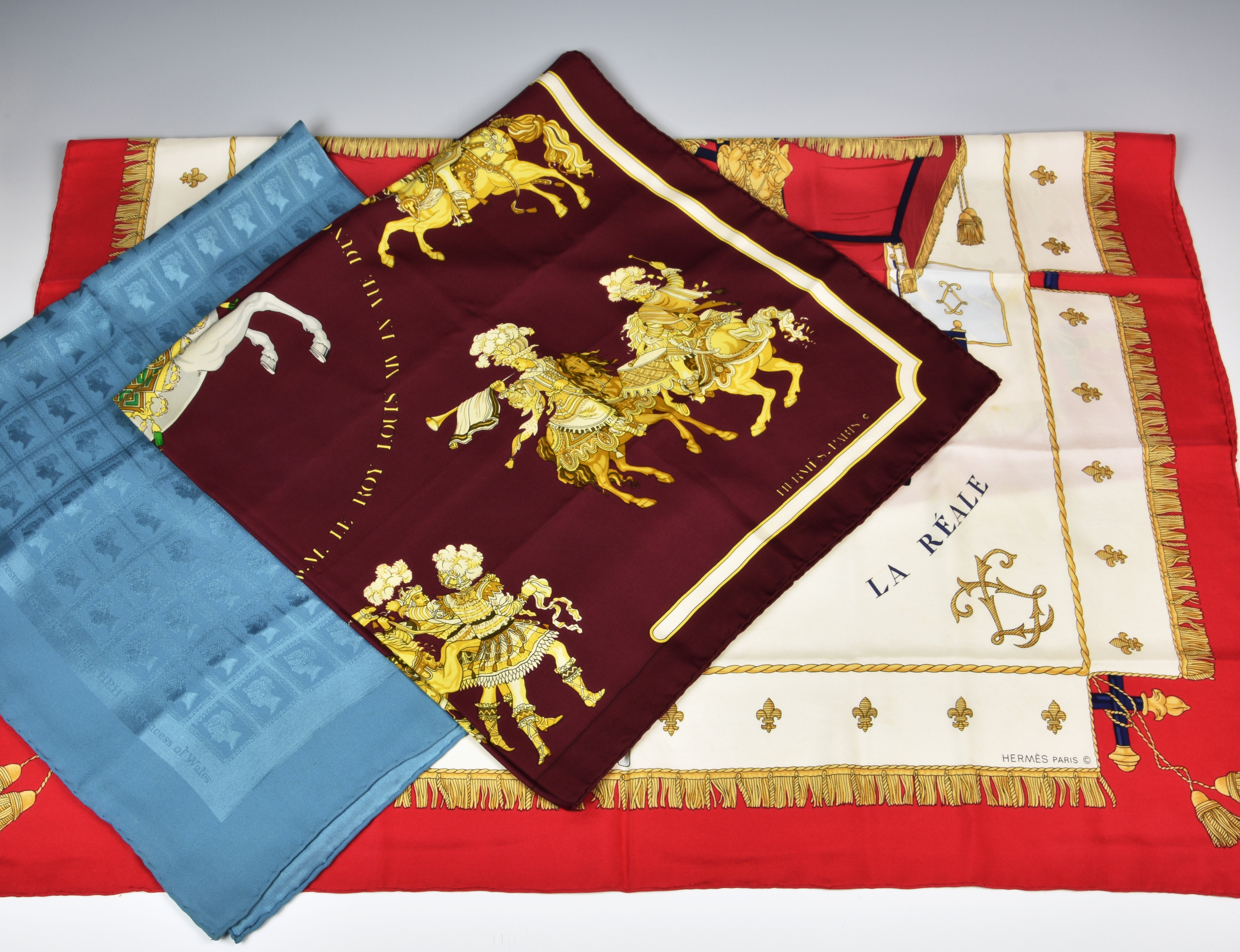 Two silk scarves by Hermes, comprising a "Carousel" scarf designed by Christine Vauxelles, 1984; and