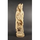 A fine quality Chinese carved ivory figure of an immortal, the bearded male figure with a basket