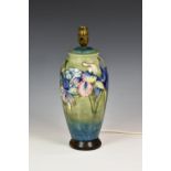 A Moorcroft Lily pattern table lamp, of baluster form, tube lined flowers in pinks, purples and