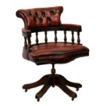 A red leather button back captain's chair by Ring Mekanikk Norway, 34.5in. (87.6cm.), high.