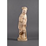 A Japanese carved ivory okimono of a lady, Meiji period (1868-1912), standing with a basket of