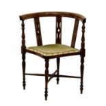 An Edwardian mahogany inlaid corner chair, the inlaid top rail over pierced splats to the stuffed