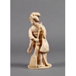 A Japanese carved ivory okimono of a lady in traditional dress, Meiji period (1868-1912), sweeping