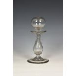 A 19th century hand blown clear glass lace maker's lamp, probably Continental, of baluster form with