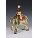 A large 1930s plaster figure of an elephant and Indian boy - possibly a fairground prize, of large