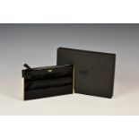 An Anya Hindmarch black patent clutch bag,