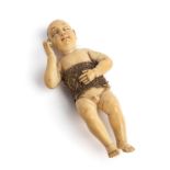 A SMALL HISPANO-PHILIPPINE IVORY FIGURE OF THE SLEEPING CHRIST CHILD (SANTO NINO DORMIDO)