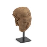 A MAJAPAHIT TERRACOTTA HEAD OF A MAIDEN, JAVA, CIRCA 15TH CENTURY