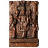 A CARVED WOOD RELIEF PANEL DEPICTING VISHNU WITH SRI DEVI AND BHU DEVI, SOUTHERN INDIA, 20TH CENTURY