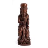 A JAVANESE CARVED WOOD FIGURE OF A MEDICINE MAN (DUKUN), INDONESIA, EARLY 20TH CENTURY