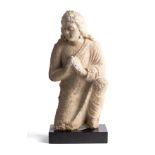 A GANDHARA STUCCO RELIEF FIGURE OF A DEVOTEE, NORTH-WEST FRONTIER REGION, INDIA (NOW PAKISTAN), 4TH/