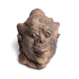 A MAJAPAHIT TERRACOTTA HEAD OF A DVARAPALA, JAVA, INDONESIA, CIRCA 14TH CENTURY