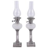A PAIR OF VICTORIAN SILVER CANDLESTICK OIL LAMPS, HAWKSWORTH, EYRE & CO. LTD., SHEFFIELD, 1897