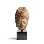 A MAJAPAHIT PUMICE HEAD OF A NOBLEMAN, JAVA, 14TH CENTURY