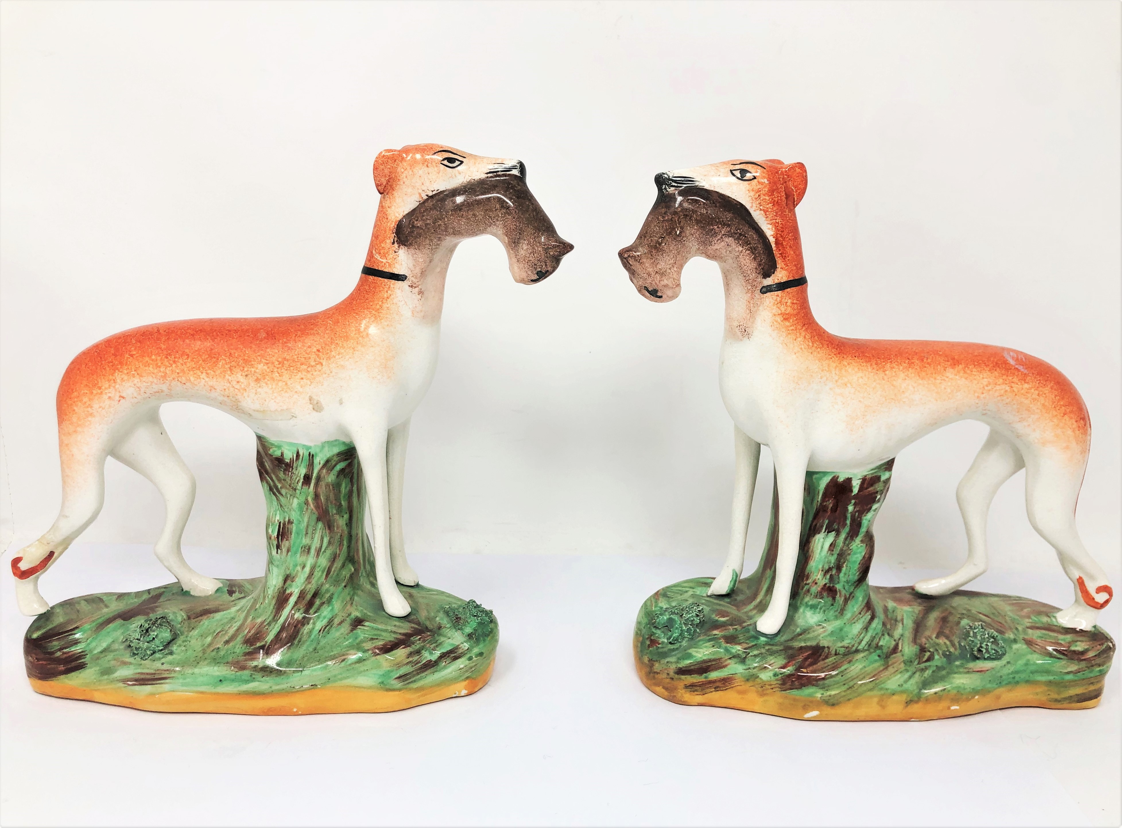 A PAIR OF STAFFORDSHIRE FIGURES OF GREYHOUNDS, CIRCA 1900