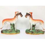 A PAIR OF STAFFORDSHIRE FIGURES OF GREYHOUNDS, CIRCA 1900