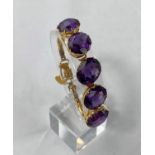 A yellow metal bracelet tests 14ct set with 5 large oval amethysts 23.9g