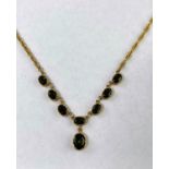 A Tourmaline set yellow metal necklace with 6 oval stones and a drop, stamped '375'