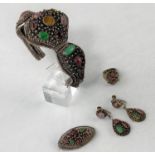 An ornate Chinese silver bracelet set with multi coloured stones with matching earrings, ring and