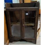 An early 20th century oak small bookcase enclosed by 2 glazed doors, height 90 cm
