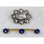 A gilt metal bar brooch set 3 lapis lazuli discs, each set centrally with a pearl; a late 19th/early
