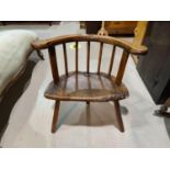 A late 17th/early 18th century rustic country made armchair, Windsor style with low stick back,
