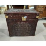 A Colonial style travel trunk covered in crocodile skin effect