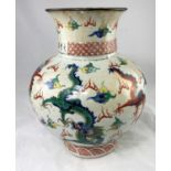 A large Chinese baluster vase decorated with red and burnt orange dragons and characters, height