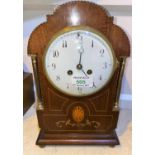 An Edwardian mantel clock in Sheraton inlaid arch top case, with white enamel dial and French drum