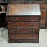 A mahogany reproduction bureau with fall front over 4 drawers