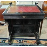 An Aesthetic Movement ebonised Davenport desk with brass gallery and red leather inset slope