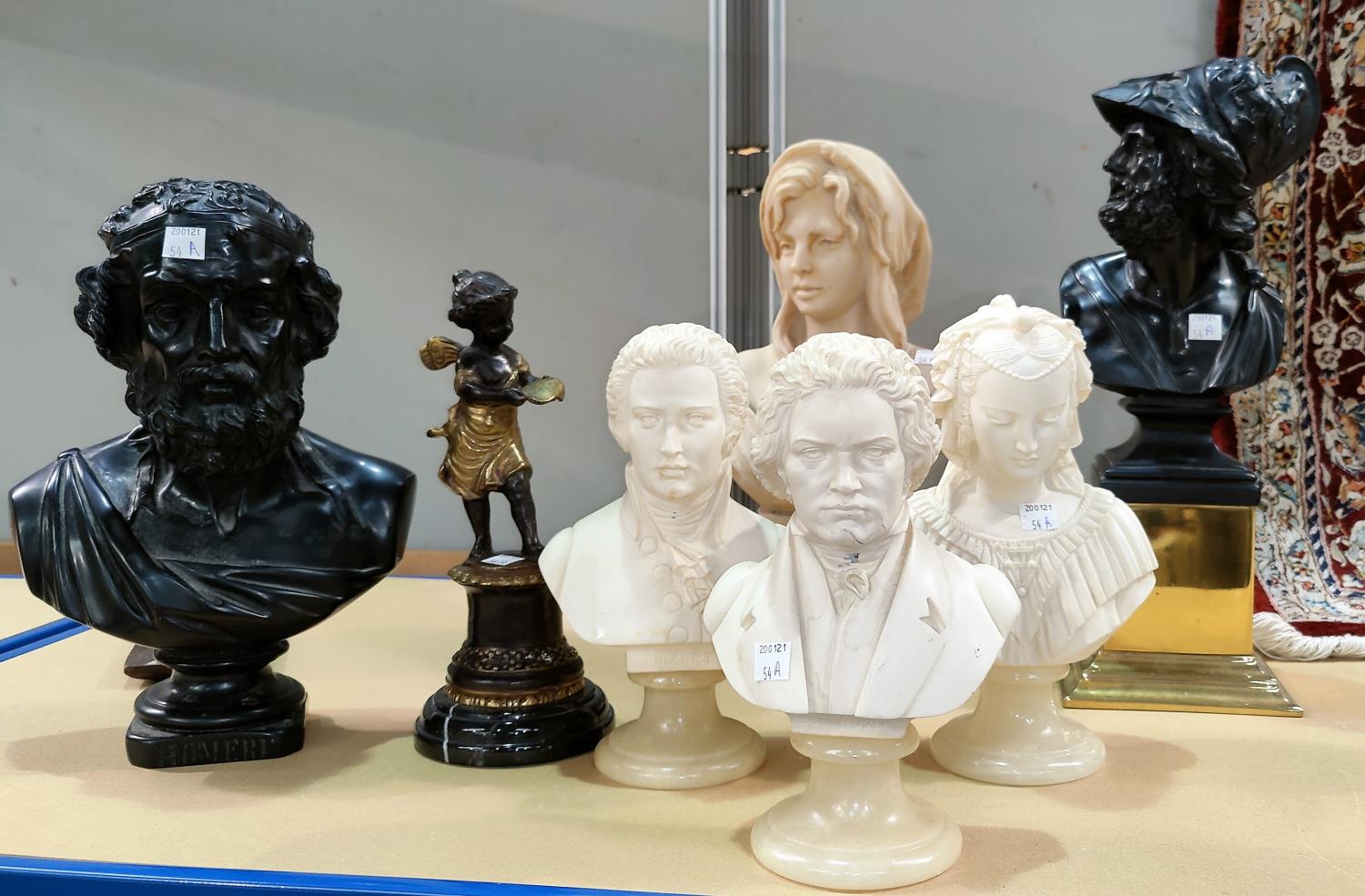 A variety of resin busts on stands in the classical manner, largest 38cm, smallest 23cm
