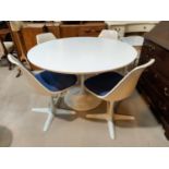 A 1960's white laminate dining suite with circular pedestal table and 4 swivel chairs in moulded