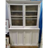 A 19th century oak full height bookcase with painted finish, with 2 glazed doors over 2 panelled