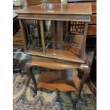 An Edwardian mahogany revolving bookcase with square top and undershelf, on cabriole legs