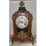 A 19th century French mantel clock in arch top boulle case with ornate ormolu finial, feet and